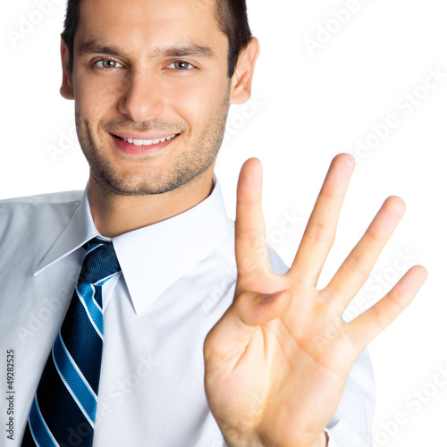 Photo: Businessman showing four fingers, isolated Businessman showing four fingers, isolated