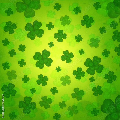 Illustration: striped four-leaved shamrocks in green old paper background striped four-leaved shamrocks in green old paper background