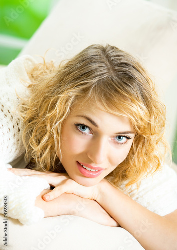 Photo: Smiling young beautiful woman, indoors Smiling young beautiful woman, indoors