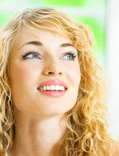 Photo: Smiling young beautiful woman, indoors Smiling young beautiful woman, indoors