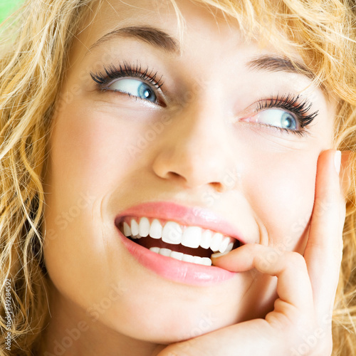 Photo: Smiling young beautiful woman, indoors Smiling young beautiful woman, indoors