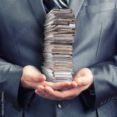 Photo: Businessman holding documents Businessman holding documents
