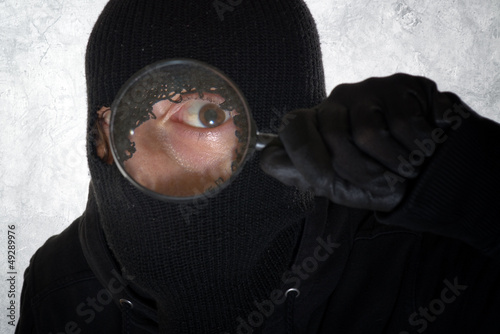Photo: Burglar with magnifying glass Burglar with magnifying glass