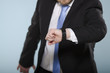 Photo: Businessman in hurry watching his clock. Businessman in hurry watching his clock.