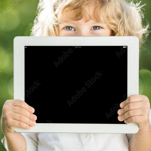 Photo: Child holding tablet PC Child holding tablet PC
