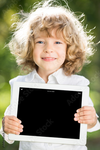Photo: Child holding tablet PC Child holding tablet PC