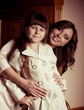 young beautiful mother and her little daughter embracing