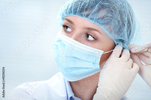 Photo: female doctor in medical gloves female doctor in medical gloves