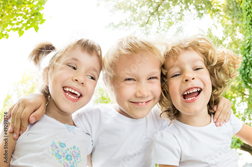 Photo: Low angle view portrait of happy children Low angle view portrait of happy children