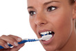Beautiful woman brushing her teeth