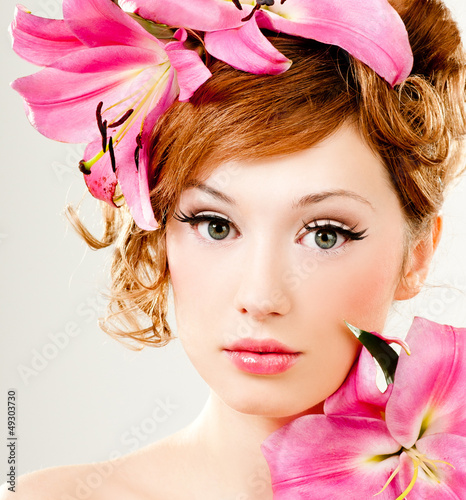 Photo: beautiful girl with pink lilies in her hair beautiful girl with pink lilies in her hair