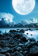 Mull moon over the rocky coast. Long exposure shot.