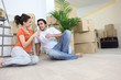 Couple moving in to flat drinking champagne