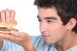 portrait of a young man with hamburger