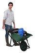 A construction worker with a wheelbarrow.