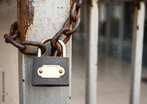 Photo: Rusted padlock on closed iron door Rusted padlock on closed iron door