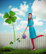 Photo: Woman watering a four leaf clover Woman watering a four leaf clover