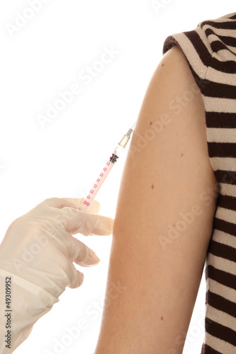 Photo: Doctor holding syringe with a vaccine in the patient shoulder, Doctor holding syringe with a vaccine in the patient shoulder,