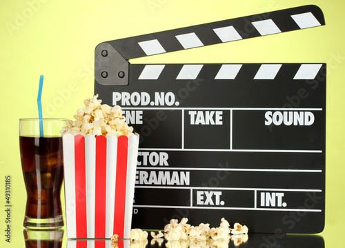 Photo: Movie clapperboard, cola and popcorn on background Movie clapperboard, cola and popcorn on background