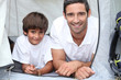 Father and son camping in a tent