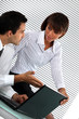 Colleagues discussing the details of a business report