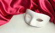 White mask and red silk fabric, isolated on white