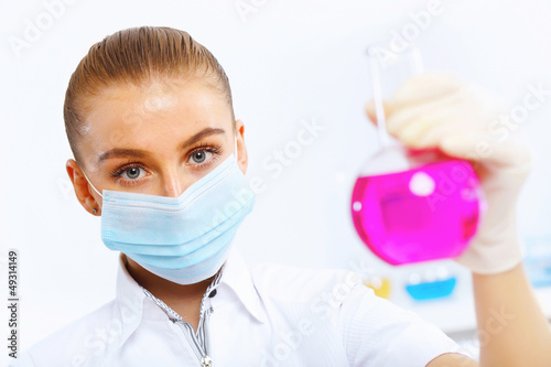 Photo: Young female scientist working in laboratory Young female scientist working in laboratory