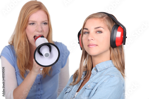 Photo: Girl shouting into speaker phone Girl shouting into speaker phone