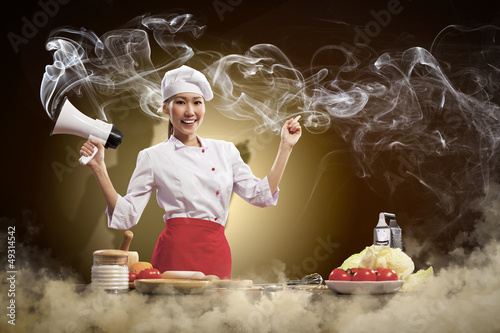 Photo: Asian female cook holding megaphone Asian female cook holding megaphone