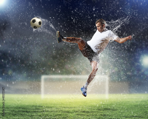 Photo: football player striking the ball football player striking the ball