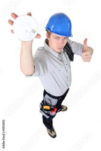 Photo: Tradesman approving of the use of smoke detectors Tradesman approving of the use of smoke detectors
