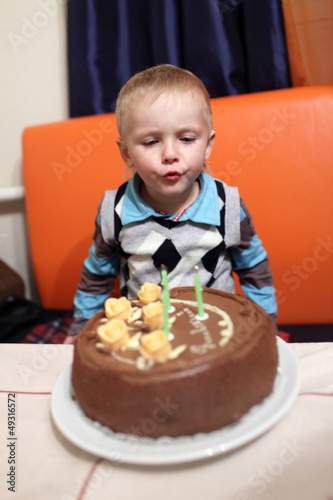 Photo: Boy blows out the candles Boy blows out the candles