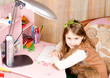 Smiling pretty little girl at her desk