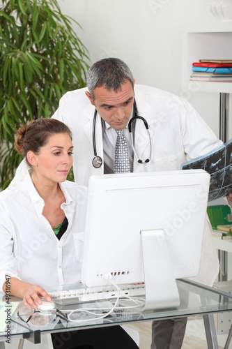 Photo: doctor and nurse discussing a case doctor and nurse discussing a case