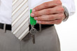 man in a suit holding a key