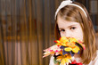Shy little girl with a bouquet of flowers