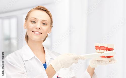 Photo: doctor with toothbrush and jaws doctor with toothbrush and jaws
