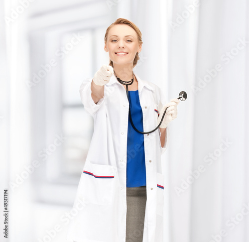 Photo: attractive female doctor pointing her finger attractive female doctor pointing her finger