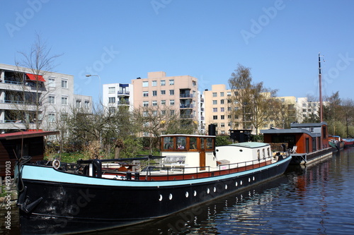 Photo: Boata in a canal of the city of Groningen(The Netherlands) Boata in a canal of the city of Groningen(The Netherlands)