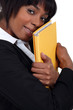 Businesswoman hugging a folder
