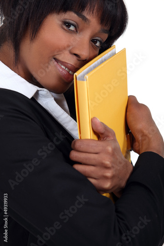 Photo: Businesswoman hugging a folder Businesswoman hugging a folder
