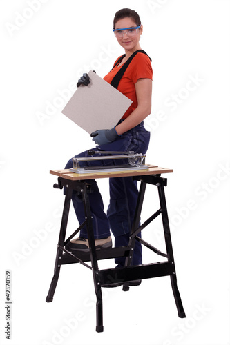 Photo: a handywoman showing a tile a handywoman showing a tile