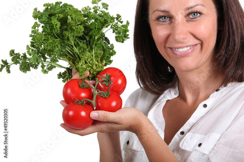 Photo: Woman holding tomatoes Woman holding tomatoes