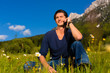 Photo: man with phone sitting in the mountains man with phone sitting in the mountains