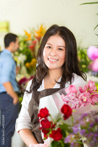 Photo: Saleswoman and customer in flower shop Saleswoman and customer in flower shop