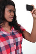 African woman taking pictures with phone