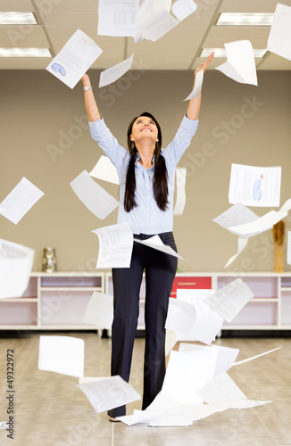 Photo: Successful businesswoman throwing papers Successful businesswoman throwing papers