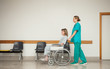 Nurse pushing the wheelchair of a female patient