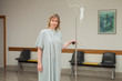Woman holding a drip stand while walking 