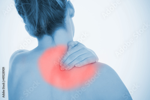 Photo: Woman rubbing highlighted shoulder pain Woman rubbing highlighted shoulder pain